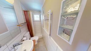 a bathroom with a sink and a toilet and a window at Mauritius MR1 in Naters +35 photos