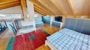 a large room with two beds and a television at Mauritius MR1 in Naters