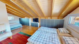 a room with two beds and a tv in it at Mauritius MR1 in Naters