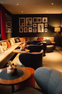 a living room with couches and tables and chairs at Me and All Hotel Dusseldorf, by Hyatt in Düsseldorf