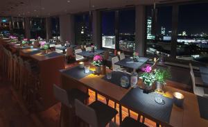 an overhead view of a restaurant with tables and chairs at Me and All Hotel Dusseldorf, by Hyatt in Düsseldorf