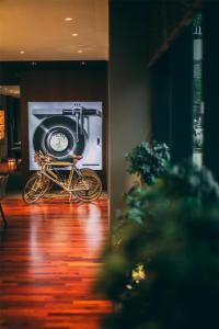 a bike parked in front of a room with a tv at Me and All Hotel Dusseldorf, by Hyatt in Düsseldorf