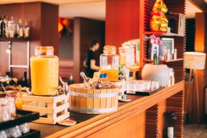 a counter with jars of orange juice on it at Me and All Hotel Dusseldorf, by Hyatt in Düsseldorf +138 photos