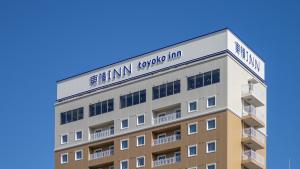 a building with a sign on top of it at Toyoko Inn Kochi in Kochi