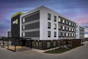 a building with a sign on the side of it at Home2 Suites By Hilton Taylor in Taylor