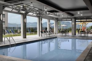 a swimming pool with tables and chairs in a building at Tempo By Hilton Pigeon Forge in Pigeon Forge