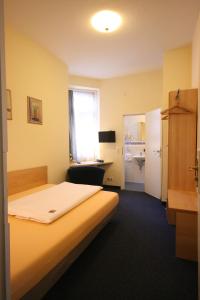 a hotel room with a bed and a desk at Altstadt Hotel in Heidelberg