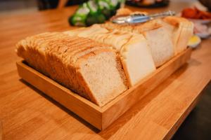 a loaf of bread on a cutting board on a table at Tequila Sunrise Podstel in Gold Coast
