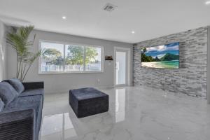 a living room with a couch and a chair at Oasis del Sol in Homestead