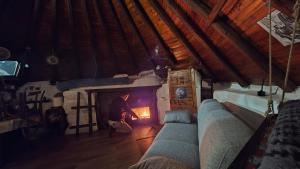 a man standing in front of a fire in a room at Rifugio Ortobene in Nuoro
