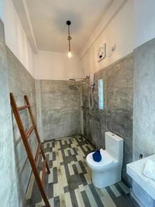 a bathroom with a toilet and a sink at Surf Gangs Arugambay in Arugam Bay