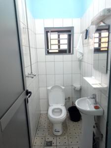 a small bathroom with a toilet and a sink at Chambre et apparts meublés, Yaoundé - FOKOU EMANA in Yaoundé