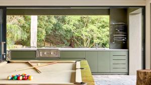 a kitchen with a stove and a large window at Grants - West Cambewarra, Longreach in West Cambewarra +37 photos