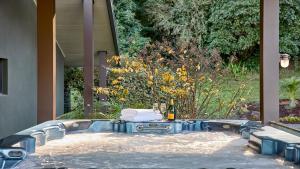 a hot tub with a table and a bottle of wine at Grants - West Cambewarra, Longreach in West Cambewarra