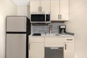 a kitchen with a sink and a refrigerator at Bluegreen Vacations Club 36, an Ascend Collection Resort in Las Vegas