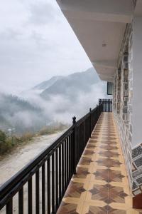 a room with a balcony with a view of the mountains at Milana Ashram in Jari