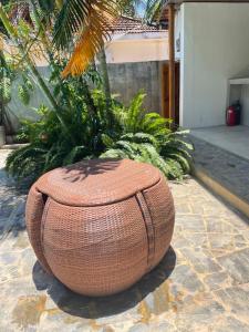 a large wicker planter sitting on a brick ground at Surf Gangs Arugambay in Arugam Bay