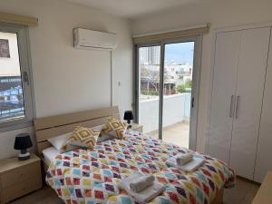 a bedroom with a bed with towels on it at 777 Stars in Paphos