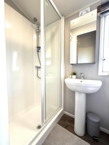 a white bathroom with a sink and a shower at Dunlin Retreat in Flamborough +79 photos