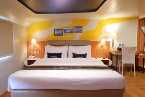 a hotel room with a large bed and a desk at Doulos Phos The Ship Hotel in Lagoi