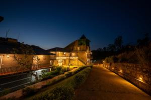 a house at night with lights on the street at Tethys Himalaya Resort in Solan +9 photos