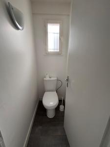 a bathroom with a toilet and a window at Maison avec plage à pied in Saint-Georges-dʼOléron