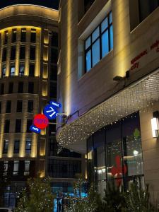 a building with neon signs in front of it at 71 East Hotel in Astana