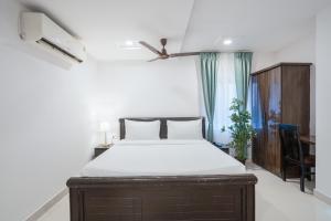 a bedroom with a bed and a desk and a window at RCC Hotels Parkview Inn Miyapur in Lingampalli +16 photos