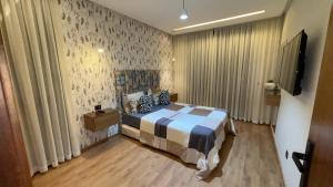 a bedroom with a bed and a television in it at CfC in Casablanca