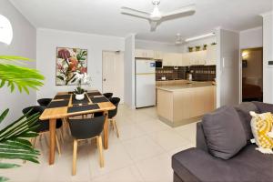 a living room and kitchen with a table and chairs at Sunset Stunner Marina Views in Larrakeyah