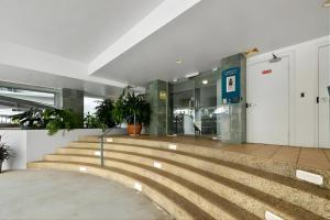 a lobby with a staircase in a building at Sunset Stunner Marina Views in Larrakeyah +34 photos