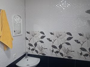 a bathroom with a flower pattern on the wall at Hotel kazbegi1 in Kazbegi +50 photos