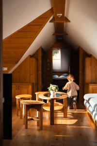 a child running in a room with a table and chairs at Apartmán 9 in Zázrivá
