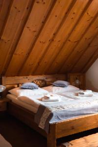 a large bed in a room with wooden ceilings at Apartmán 9 in Zázrivá