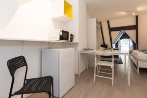 a small kitchen and living room with a microwave at RedLight District Apartment 2 in Amsterdam