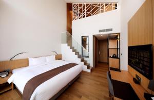 a bedroom with a large bed and a staircase at Midas Hotel & Resort in Gapyeong
