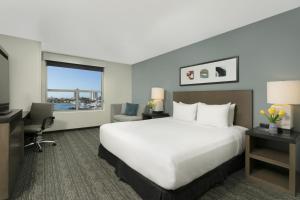 a hotel room with a large bed and a desk at Hyatt House San Juan in San Juan +149 photos
