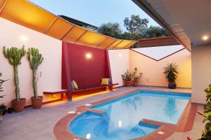 an indoor swimming pool in a house with plants at The Bordeaux Door in Egina