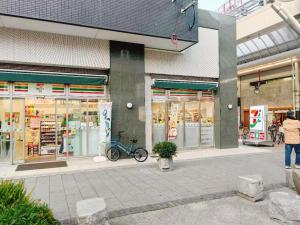 a person standing in front of a store at ゲストハウス瓦町 in Takamatsu