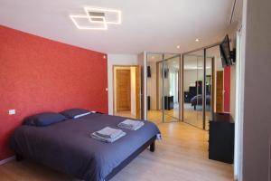 a bedroom with a bed and a red wall at Bastide des Civayeres in Veynes