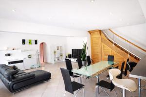 a dining room with a glass table and chairs at Bastide des Civayeres in Veynes