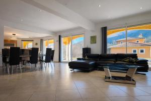 a living room with a couch and a dining room at Bastide des Civayeres in Veynes