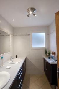 a bathroom with two sinks and a window at Bastide des Civayeres in Veynes +32 photos
