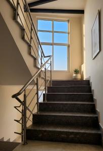 a staircase in a house with a window at The Nomad's Nest in New Delhi