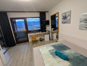 a bedroom with a bed with a desk and a window at Herzogberghof in Kindberg +153 photos