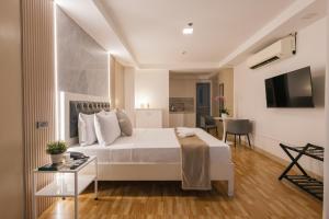a bedroom with a large white bed and a table at Skypark Bay Hotel in Manila
