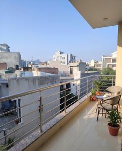 a balcony with a view of a city at The Nomad's Nest in New Delhi