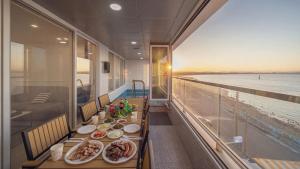 a table with plates of food on a cruise ship at Pohang Etoile Poolvilla in Pohang