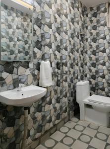 a bathroom with a sink and a toilet at The Nomad's Nest in New Delhi