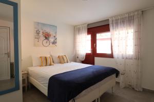 a bedroom with a bed and a window at The Bordeaux Door in Egina +21 photos